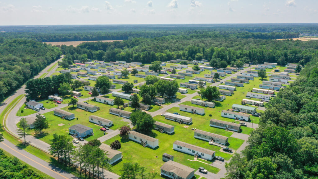 an aerial view of a large rv park surrounded by trees